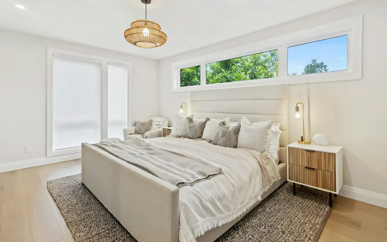 Bright, freshly made bedroom in a home cleaned and ready to hand over
