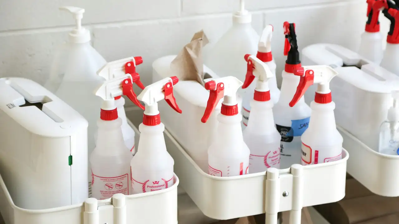 Professional spray bottles and cleaning supplies ready for a job