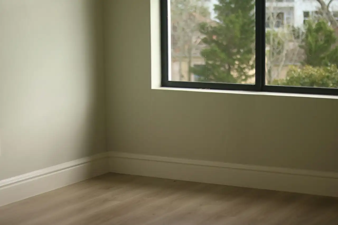 Empty room with clean floors and baseboards, ready for the final walkthrough